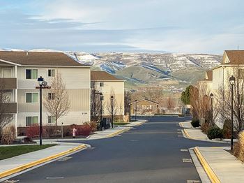 A street with houses with mountains in the background
